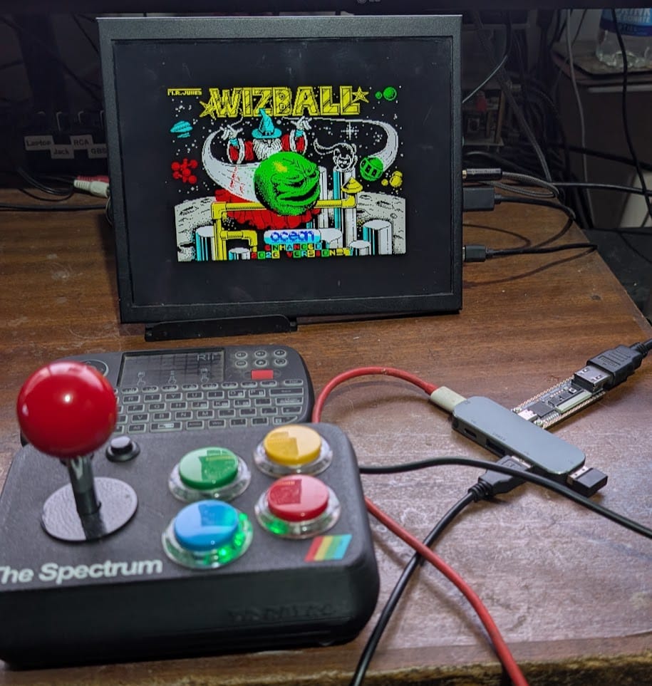 The Enhanced Edition's title screen on a small monitor, running on The Spectrum, whose joystick sits in front. Photo from the release page.